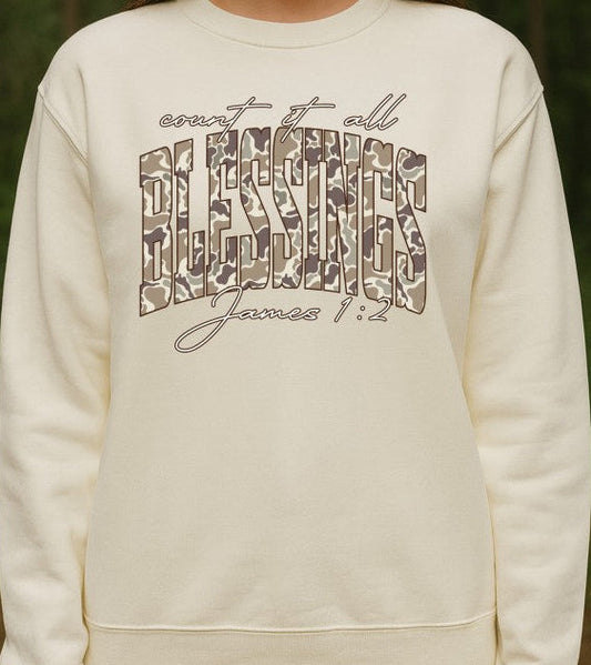 White sweatshirt with Count it all blessings james 1:2 text camo design against a natural background