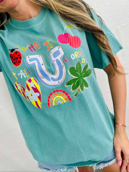 Person wearing a teal t-shirt with colorful graphics and text.