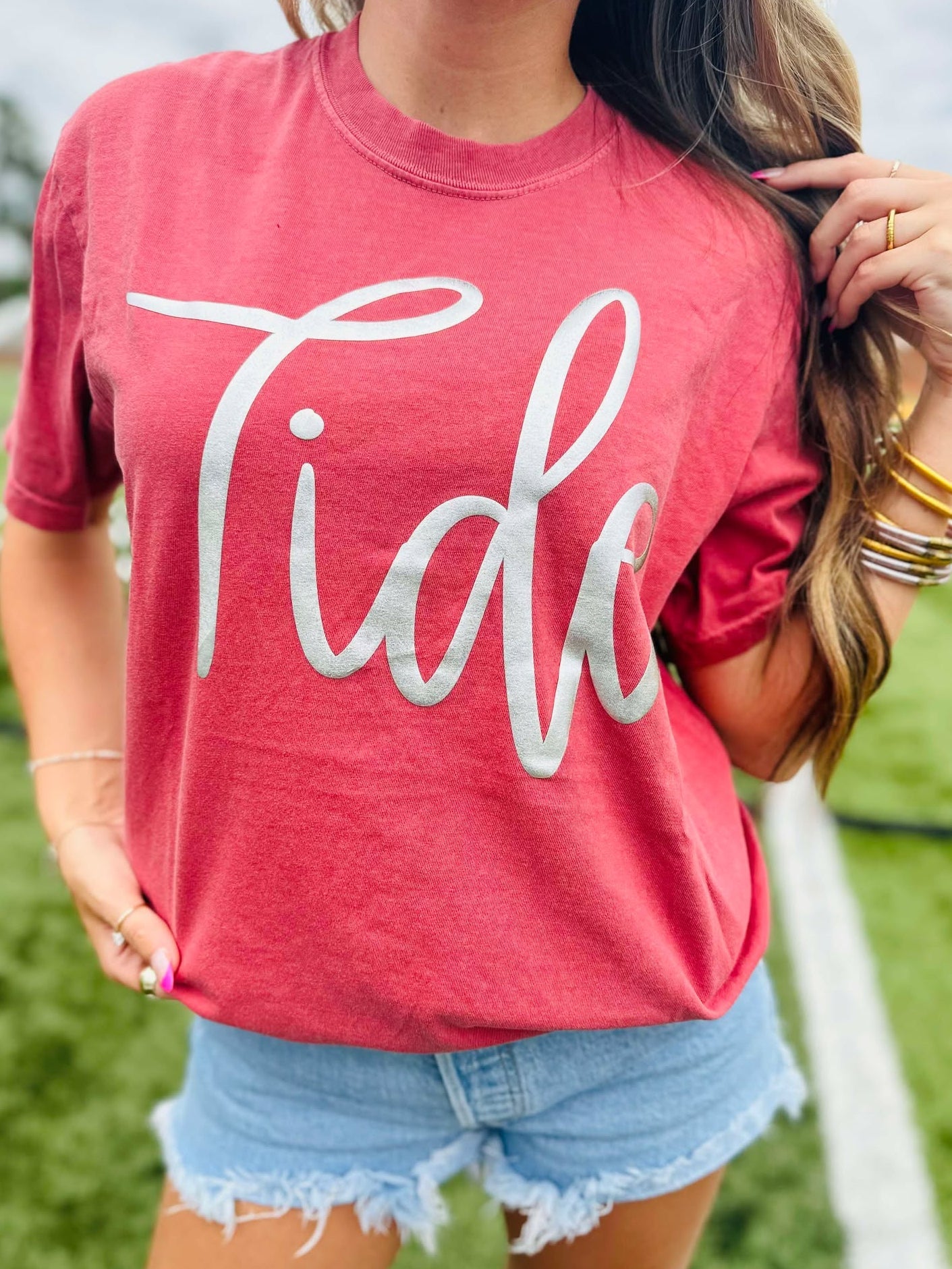 Person wearing a red 'Tide' t-shirt outdoors
