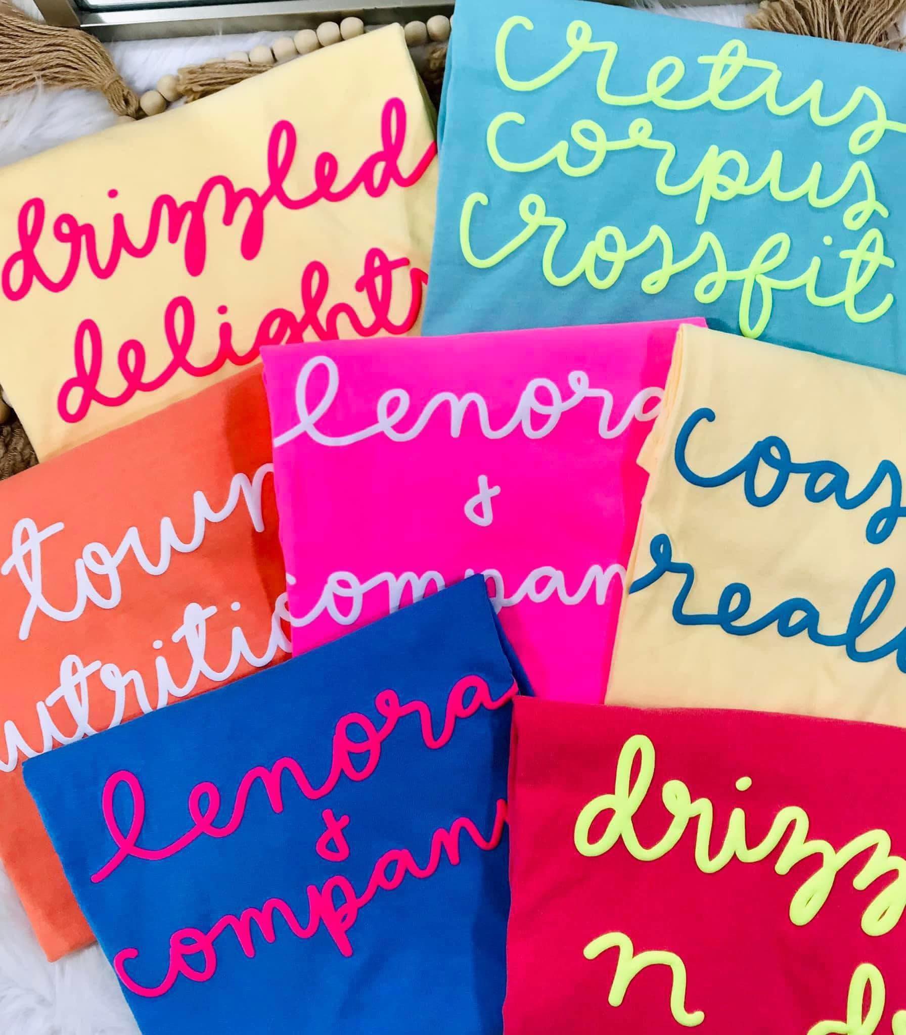 Colorful tote bags with text on a white surface