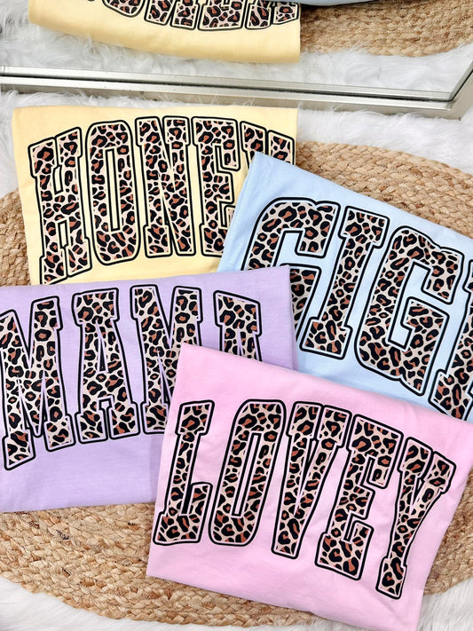 Set of towels with leopard print text on a textured surface