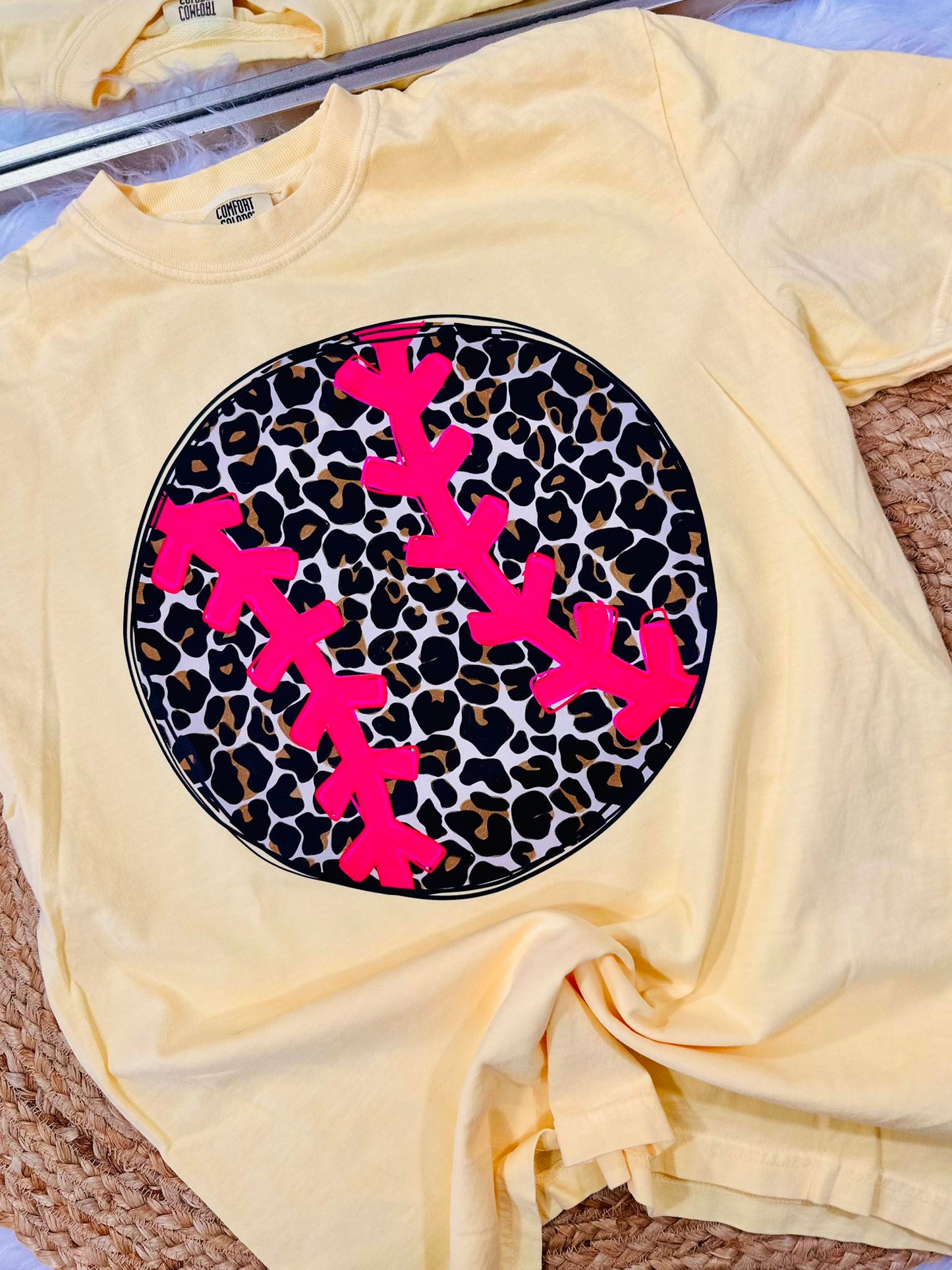 Yellow t-shirt with pink antlers on a leopard print background