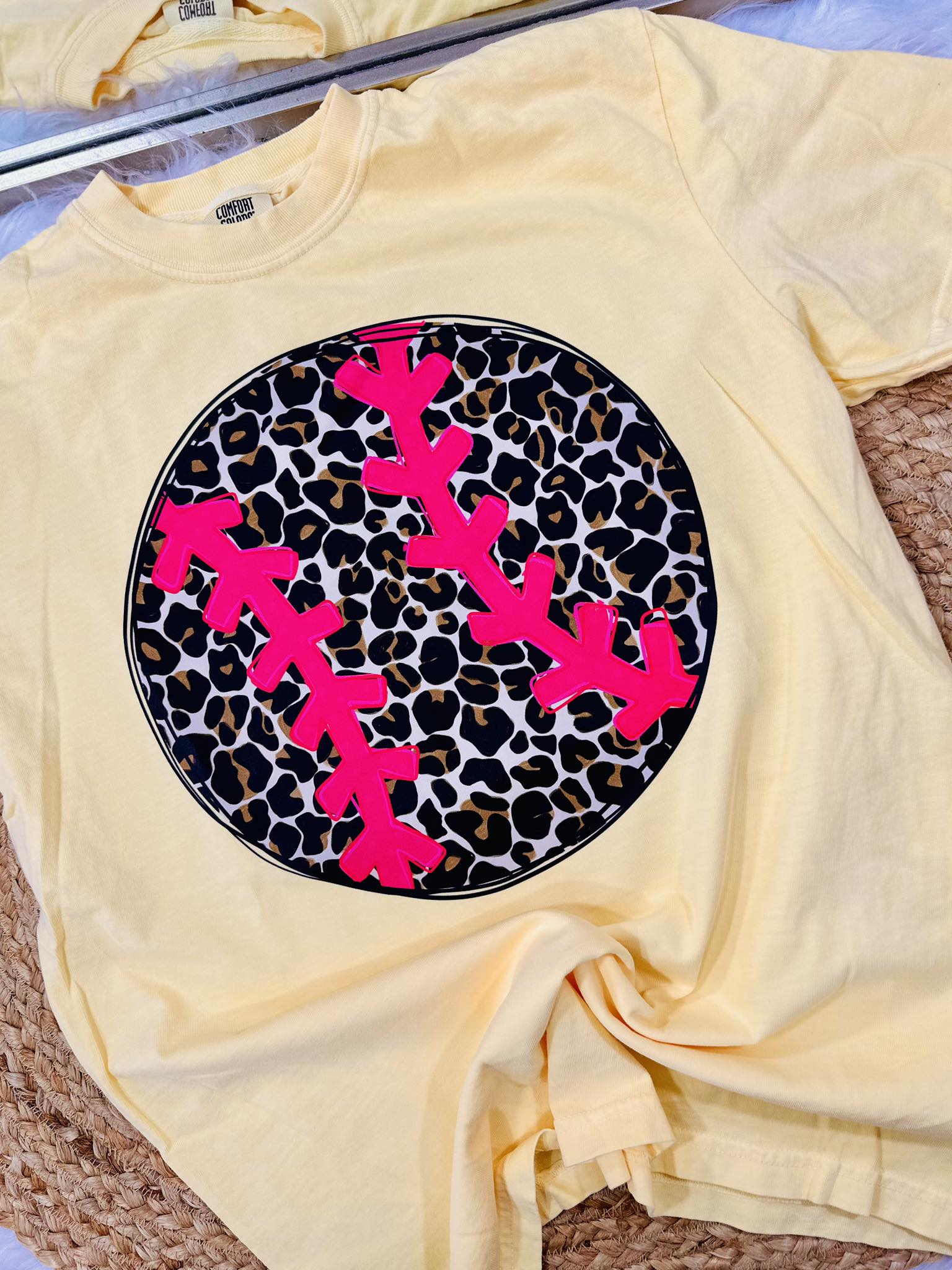 Yellow t-shirt with pink antlers on a leopard print background