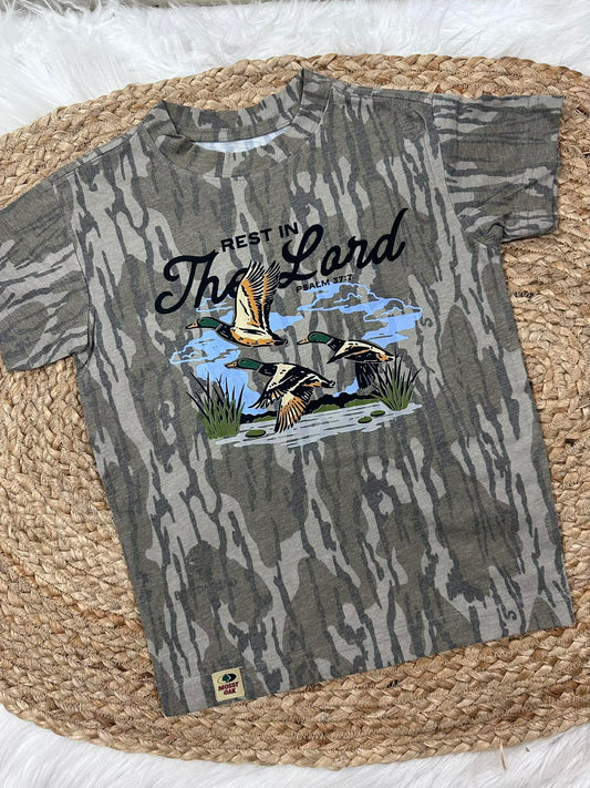 Camouflage-patterned t-shirt with duck design and text on a woven surface