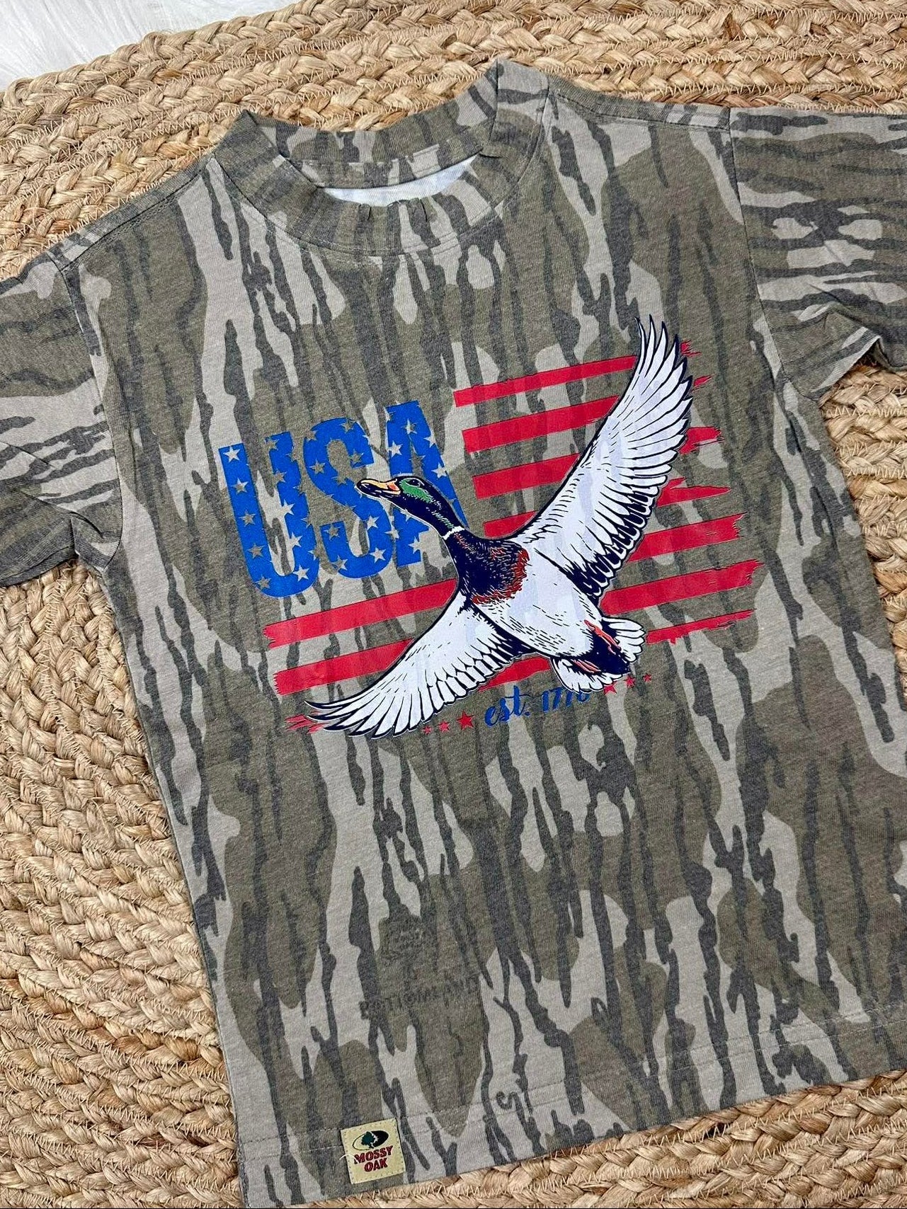 Camouflage t-shirt with USA and mallard duck like  eagle design on a woven mat