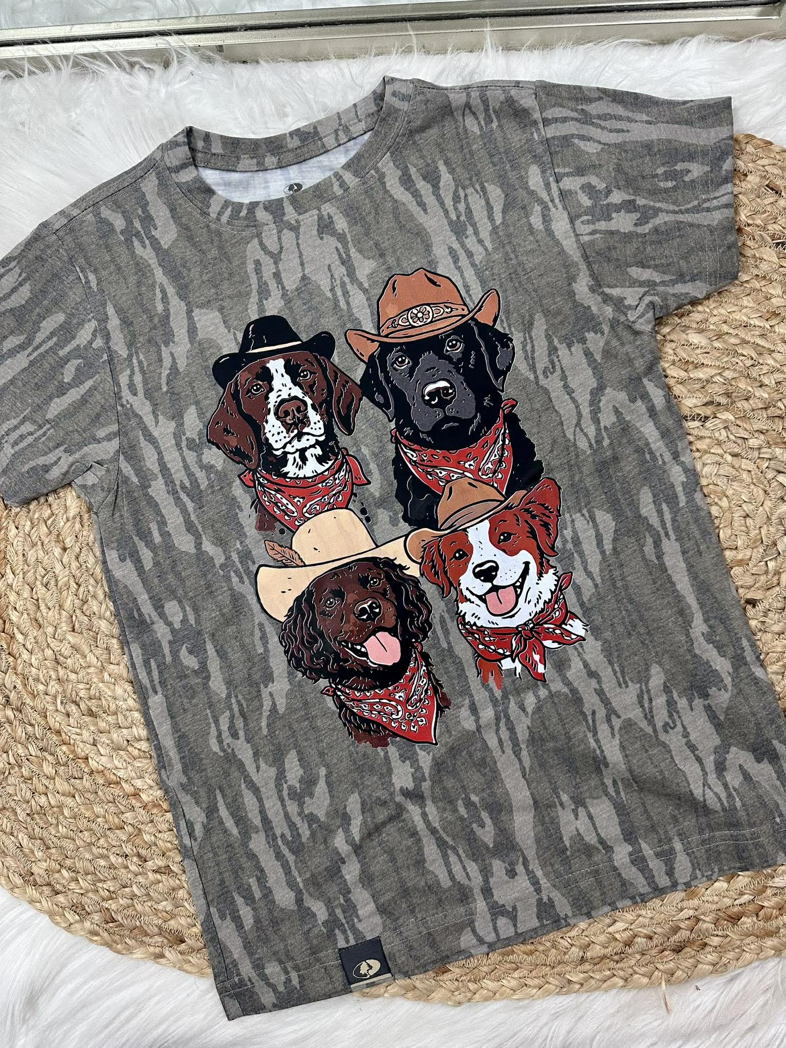 Gray t-shirt with illustrations of dogs wearing hats and bandanas on a textured surface.