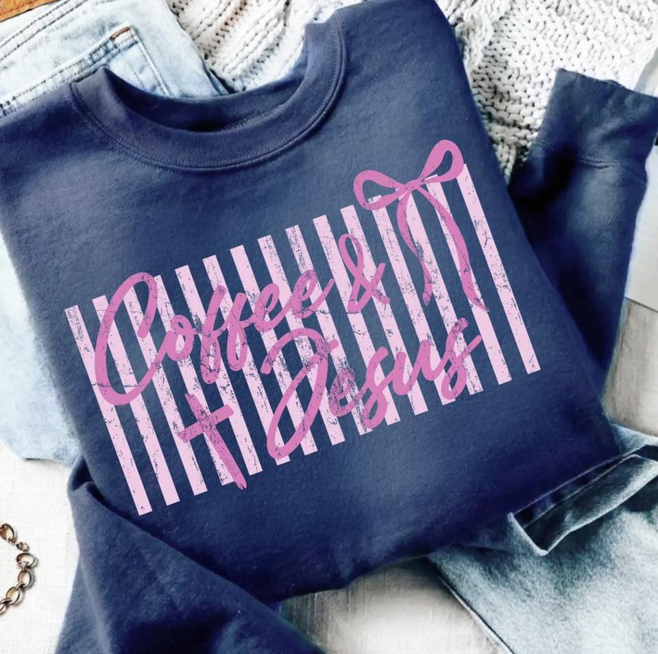 Navy sweatshirt with 'Coffee & Jesus' text in pink on a textured surface