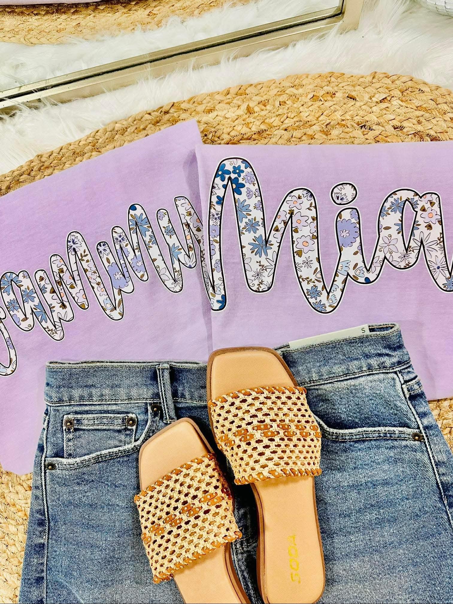 Pair of beaded sandals on jeans with a purple pillow and decorative text in the background
