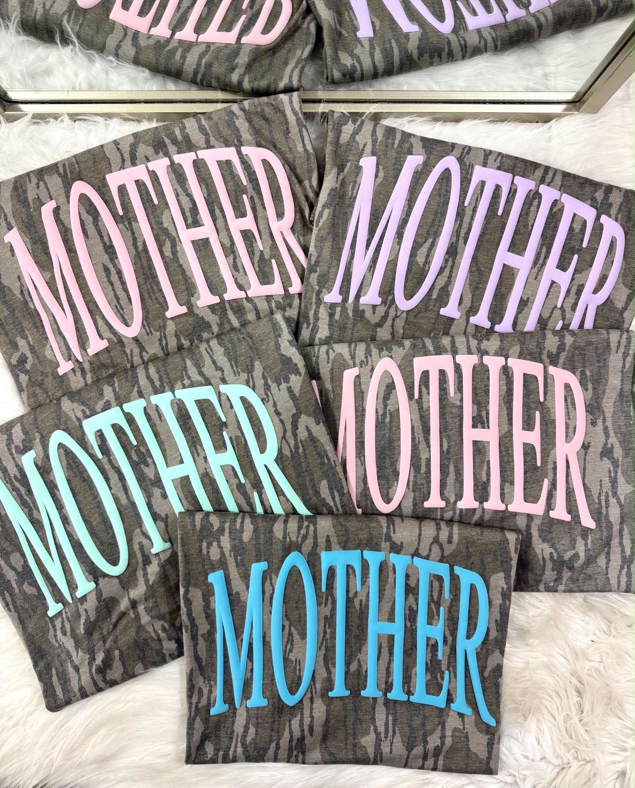 Gray marbled coasters with 'MOTHER' text in various colors on a white surface.