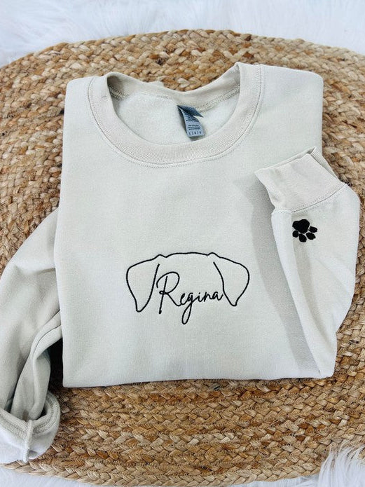 Beige sweatshirt with Dog Ears 'Regina' design on a woven mat