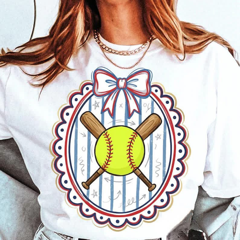 White t-shirt with a softball design featuring a bow and crossed bats on a white background.