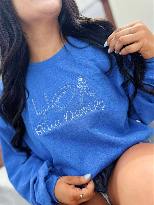 Person wearing a blue sweatshirt with 'Blue Devils' text and logo.