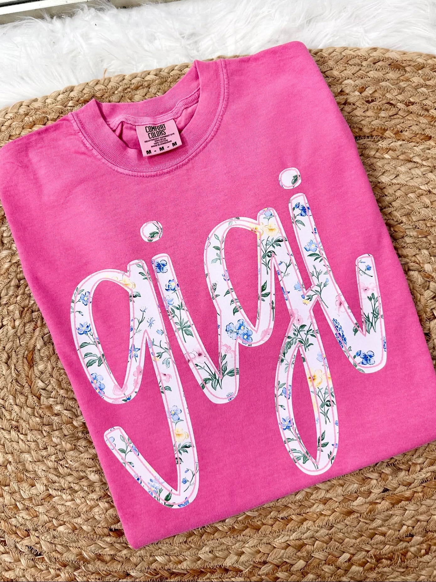 Crunchberry Comfort Color tee sweatshirt with floral 'gigi' graphic dtf text on a textured surface