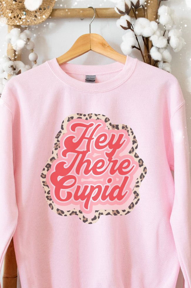A pink Gildan sweatshirt with 'Hey There Cupid' text and a leopard print pattern on the front.